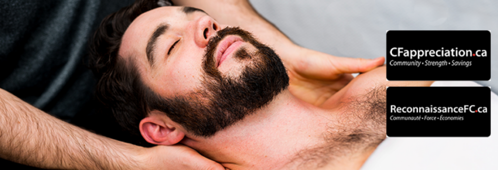 Man lying on massage table having shoulders massaged