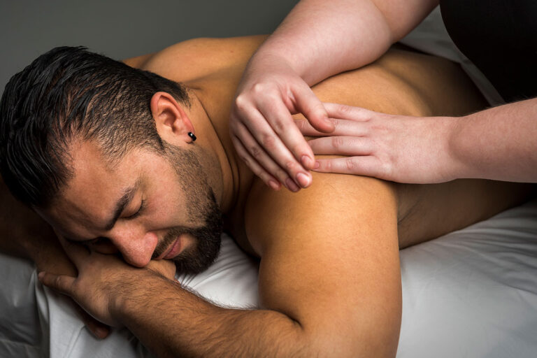 Man having shoulder massaged